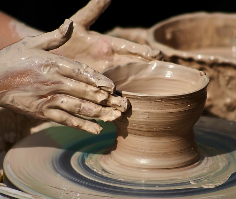 Wet hands centering clay on the wheel