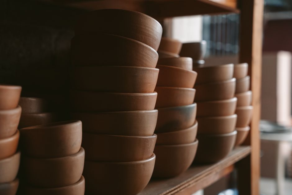 Shelves stacked with dark stoneware bowls